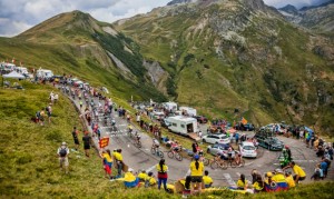Col du Glandon, France - 24 July 2015: The peloton riding in a beautiful curve at Col du Glandon in Alps during the stage 19 of Le Tour de France 2015.